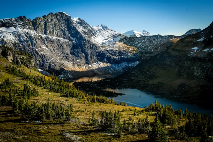 Alpine lake surrounded by snow-capped peaks at Glacier National Park