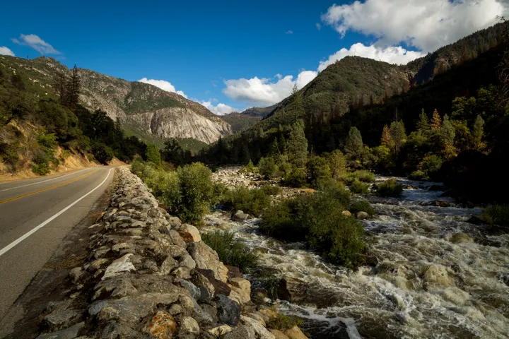 Road alongside a rushing river on the drive into Yosemite